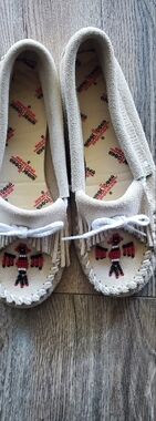 Minnetonka Women’s Beige Thunder Bird Fringe Moccasins
